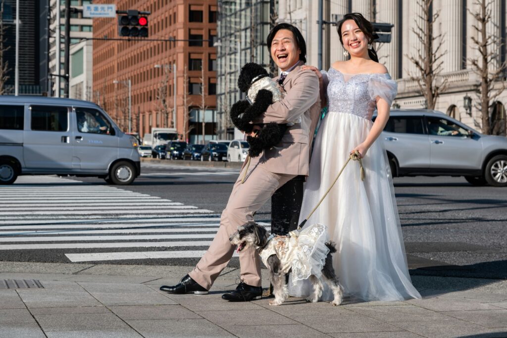 bride and groom walking in the city with their dogs