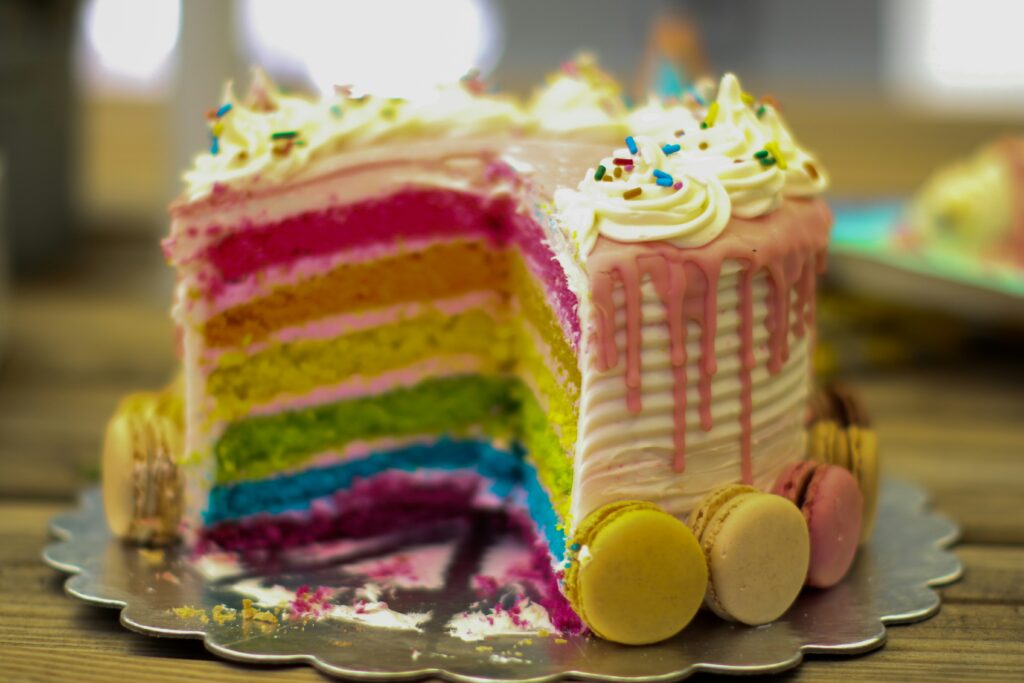 fun and detailed rainbow birthday cake with spinkles and macaroons